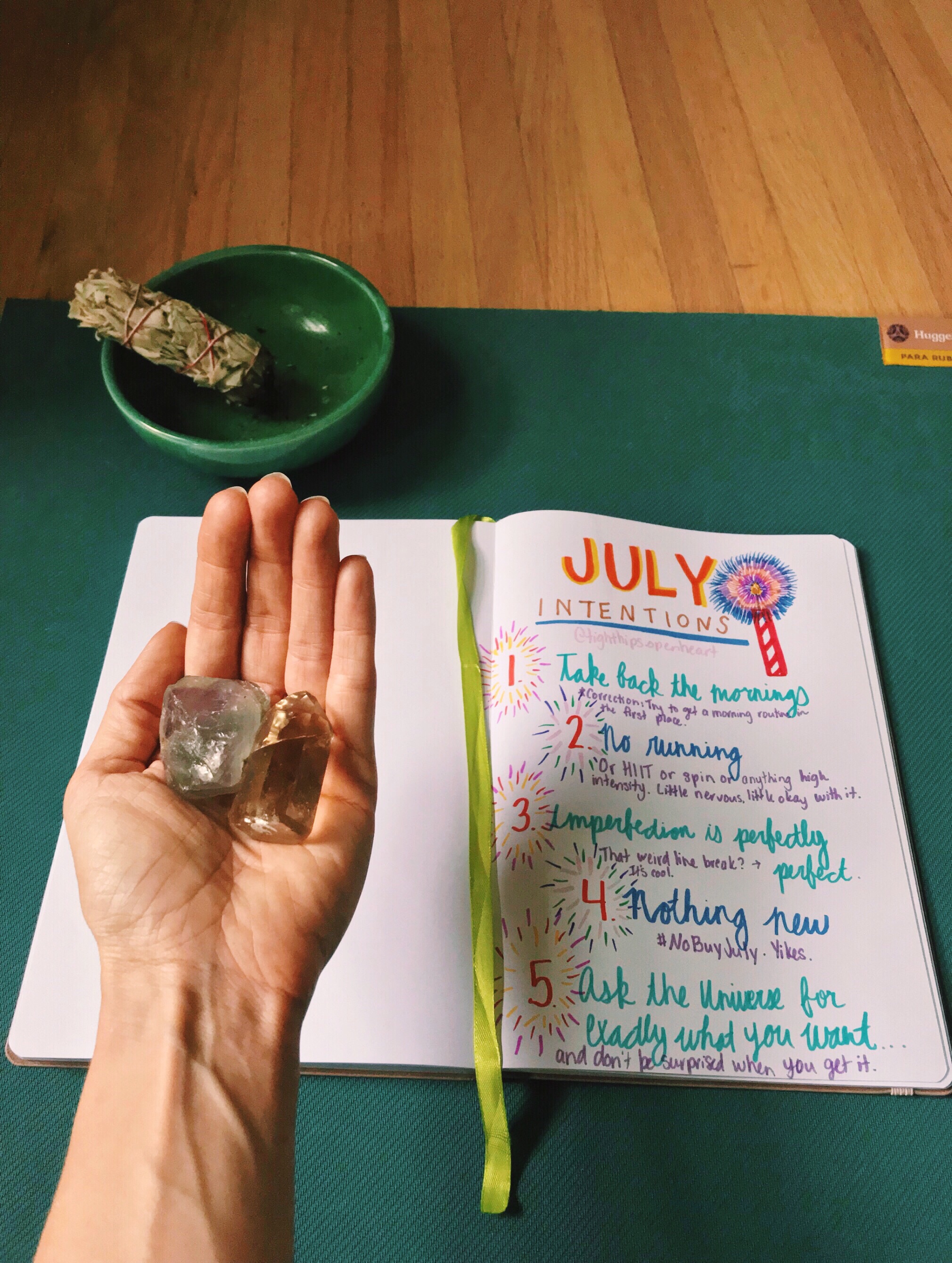 July intentions written out with crystals and sage